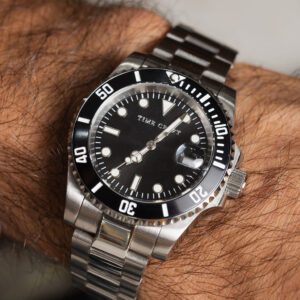 Black mechanical diver watchmaking kit with movement, tools and parts laid out