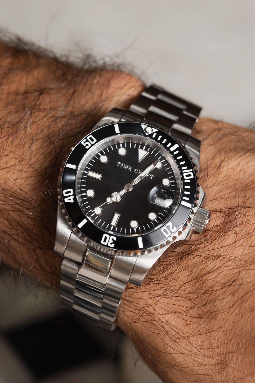 Black mechanical diver watchmaking kit with movement, tools and parts laid out